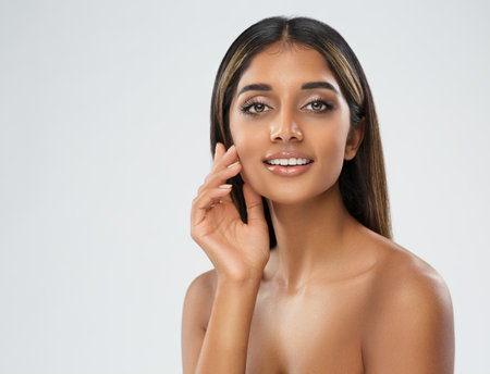 Young Woman perfect Healthy Teeth Smile over White. Beautiful Indian Girl with Natural Makeup. Women Skin and Dental Care. Happy Beauty Model Smiling Faceの写真素材