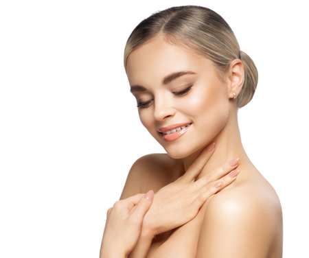 Women Body and Face Skin Care. Beautiful Girl Massage Neck. Happy Young Woman Portrait with Smooth Make up and Beige Nails isolated White. Lifting Treatmentの写真素材