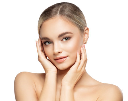 Beautiful Woman with Smooth Skin. Beauty Model with Perfect Make up holding Face in Hands isolated White. Facial Lifting Massage and Spa Treatment. Plastic Surgeryの写真素材