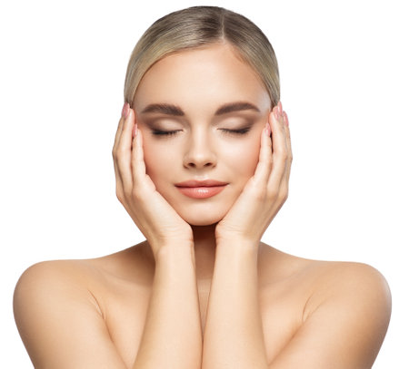 Woman Face Lifting Treatment. Women Facial and Body Skin Care. Beauty Model holding Head in Hands with Closed Eyes. Beautiful Girl Massage Face over Whiteの写真素材