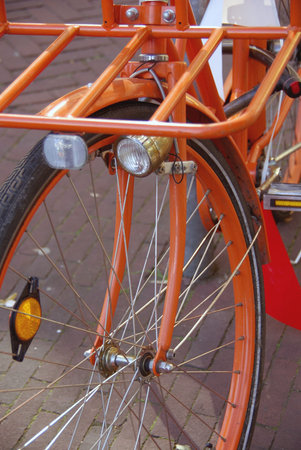 The front wheel of an orange bicycleの写真素材