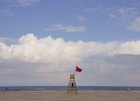 The chair of a beach watch at the beach with a cloudy skyの写真素材