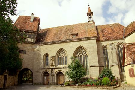 A archway and a church in Rothenburg, Germanyの写真素材