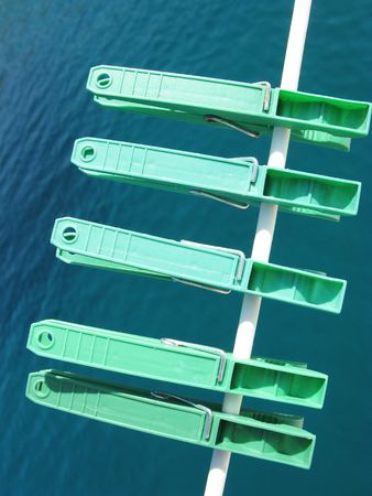 Green clothespins at a lineの写真素材