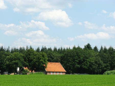 A farmhouse with grasslandの写真素材