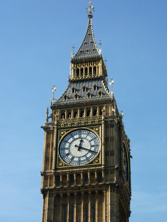 Big Ben the great bell of the clock tower of the palace of Westminster in London opposite a blue sky