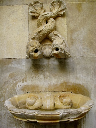A with fishes decorated historic drinking fountain in the streets of Lisbon in Portugalの写真素材