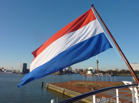 The Dutch flag on the back of a ship in the Meuse in Rotterdamの写真素材