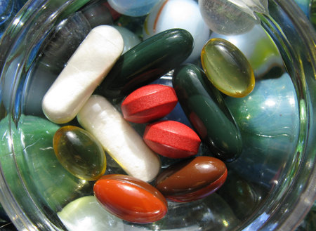 Colorful pills in a bowl of glass