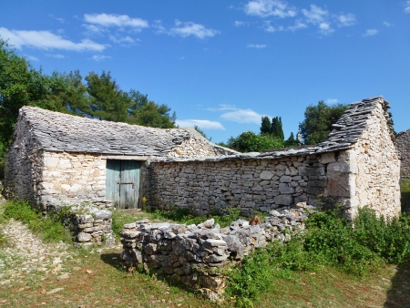 The historic trim houses in the uninhabited village Humac on the island Hvar in Croatiaの写真素材