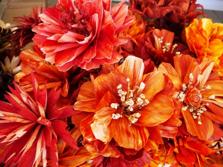 Colorful orange and red artificial flowersの写真素材