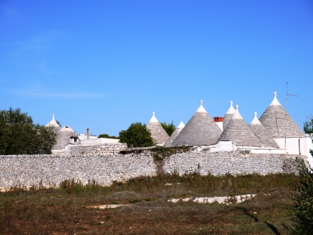 A historic trulli farmhouse in a courtyard near Locorotondo in Puglia in Italyの写真素材