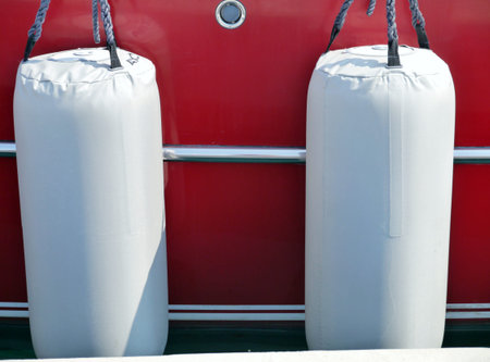 A red sailing yacht with white fendersの写真素材