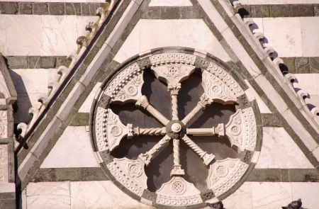 A rose window of the baptistery in Pestoia in Tuscany in Italyの写真素材