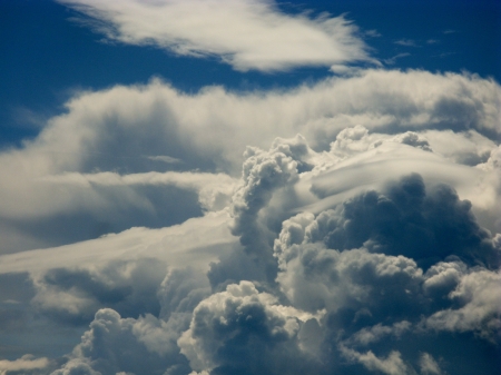 Cumulus clouds by changing weather opposite a blue skyの写真素材