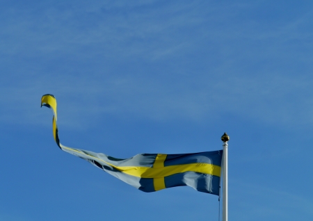 A Swedish pennant opposite a blue skyの写真素材