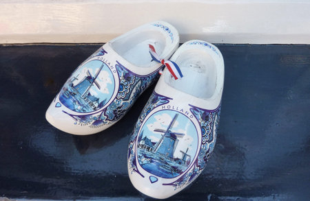 Wind mills painted on Delft blue wooden shoos of porcelain