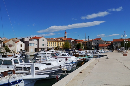 Ancient wooden fishing boats in the small harbor of Betinaの写真素材