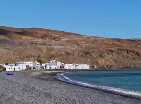 The bay and the white houses of the fishing village Pozo Negro at the Atlantic ocean on the Island...