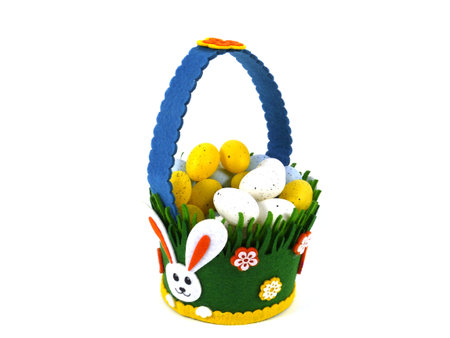 A decorated basket of felt filled with plastic Easter eggs in pastel colors