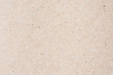beige paper board with small colorful sprinklesの写真素材