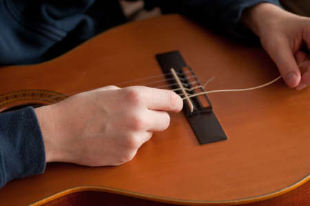 boy strings his guitarの写真素材
