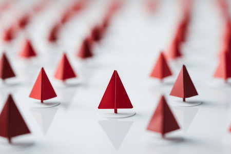 Leadership and success concept. Red paper boats on a white backgroundの素材