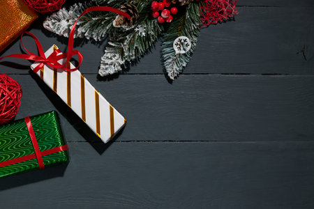 Colorful gift boxes and Christmas decorations on wooden background with copy space. Top view....