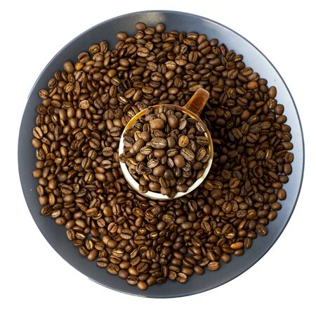 A cup full of coffee beans and a plate with coffee beans isolated on white.の写真素材