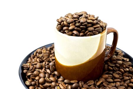 Cup with coffee beans and a plate with coffee beans  isolated on whiteの写真素材