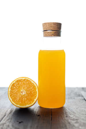 Glass of orange juice on wooden table with fresh sliced fruits of orange. Top view.の写真素材