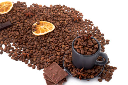Coffee beans, pieces of chocolate, dried orange slice and a cup with coffee beans isolated on whiteの写真素材