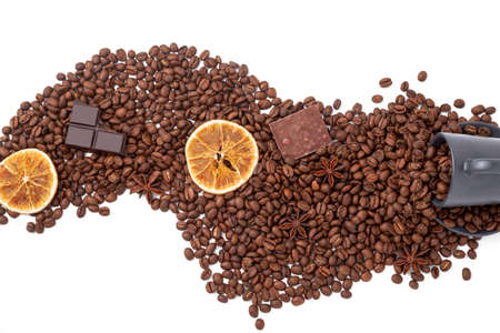 Coffee beans, pieces of chocolate and dried orange slice arising from a cup of coffe. Isolated on white. Top view.の写真素材