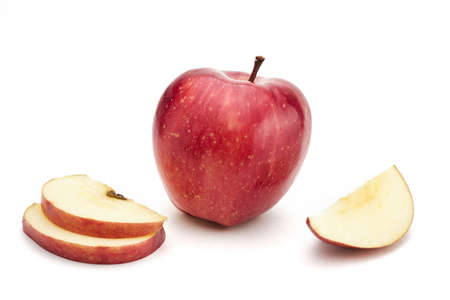 Ripe red apple with sliced apple pieces isolated on white backgroundの写真素材