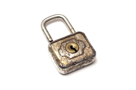 An old padlock isolated on white backgroundの写真素材