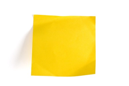 Blank yellow memo note isolated on whiteの写真素材