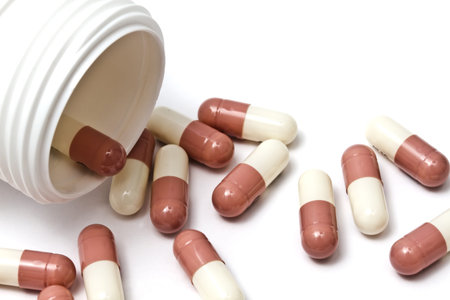 Capsules and bottle isolated on white background
