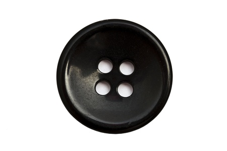 Black cloth button closeup on white backgroundの写真素材