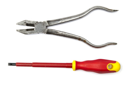 Pliers and screwdriver closeup on white background