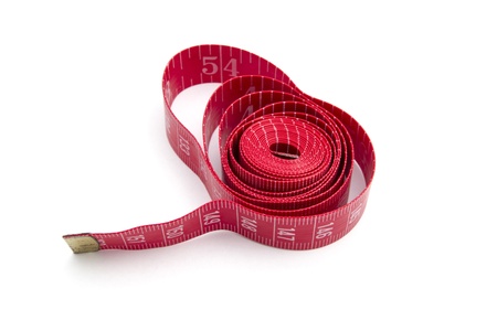 Red tape measure closeup on white background の写真素材