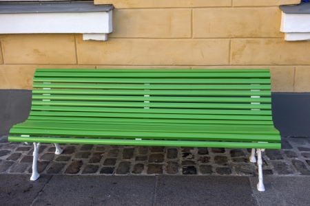 Green bench in the streetの写真素材