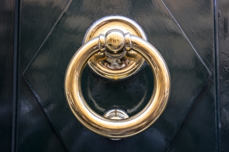  circle iron door-handle on black doorの写真素材