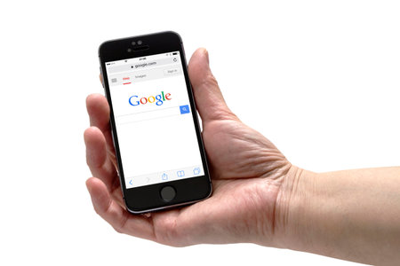 Iphone 5s in a hand isolated on white background