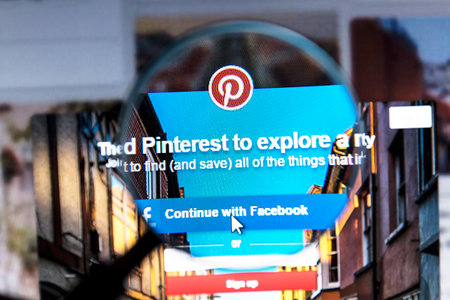 Close up of Pinterest website under a magnifying glass. Pinterest is a web and mobile application company, which operates an eponymous photo sharing websiteのeditorial素材
