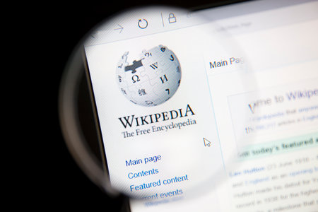 Wikipedia website under a magnifying glassのeditorial素材