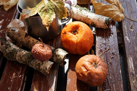 Spoiled, moldy and damaged kiwi, peach and apple on old wooden  table, unhealthy eatingの写真素材