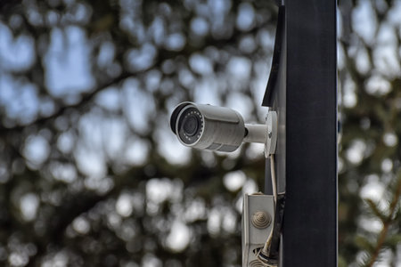 Security camera on blurred outdoors background.