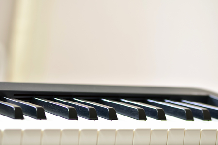Keys of a digital piano, soft focusing, creative mood. Midi piano keyboard for playing digital music and making remixes.の写真素材