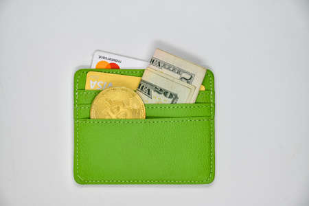 New realities - bitcoin (peer-to-peer payment system) and other investment instruments, cash and credit cards, in a citizen's walletの写真素材