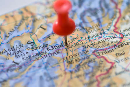 Kabul, Afghanistan on globe map atlas with red push pin thumbtack marker in macro closeup of Middle Eastern Map.の写真素材